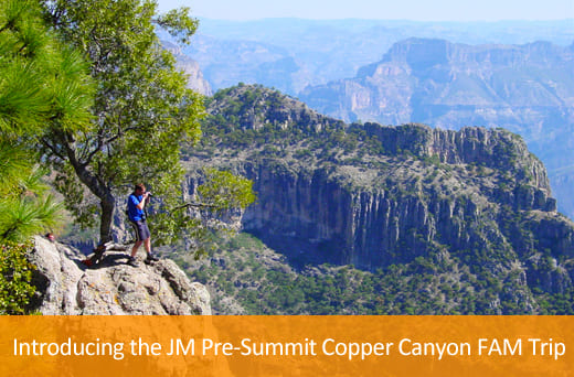 man taking photo of the copper canyon