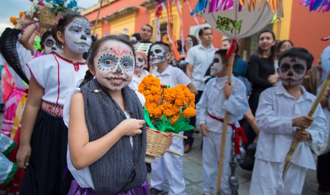 A girl carries marigolds