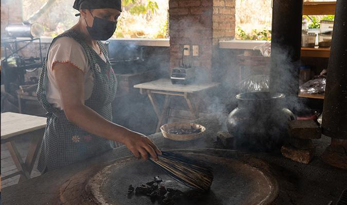 foodie tour in oaxaca in portozuelo woman over comal