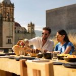 otro oaxaca couple eating in communal table