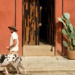 otro oaxaca couple outside entrance with dog