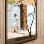 otro oaxaca man walking in front of mirror